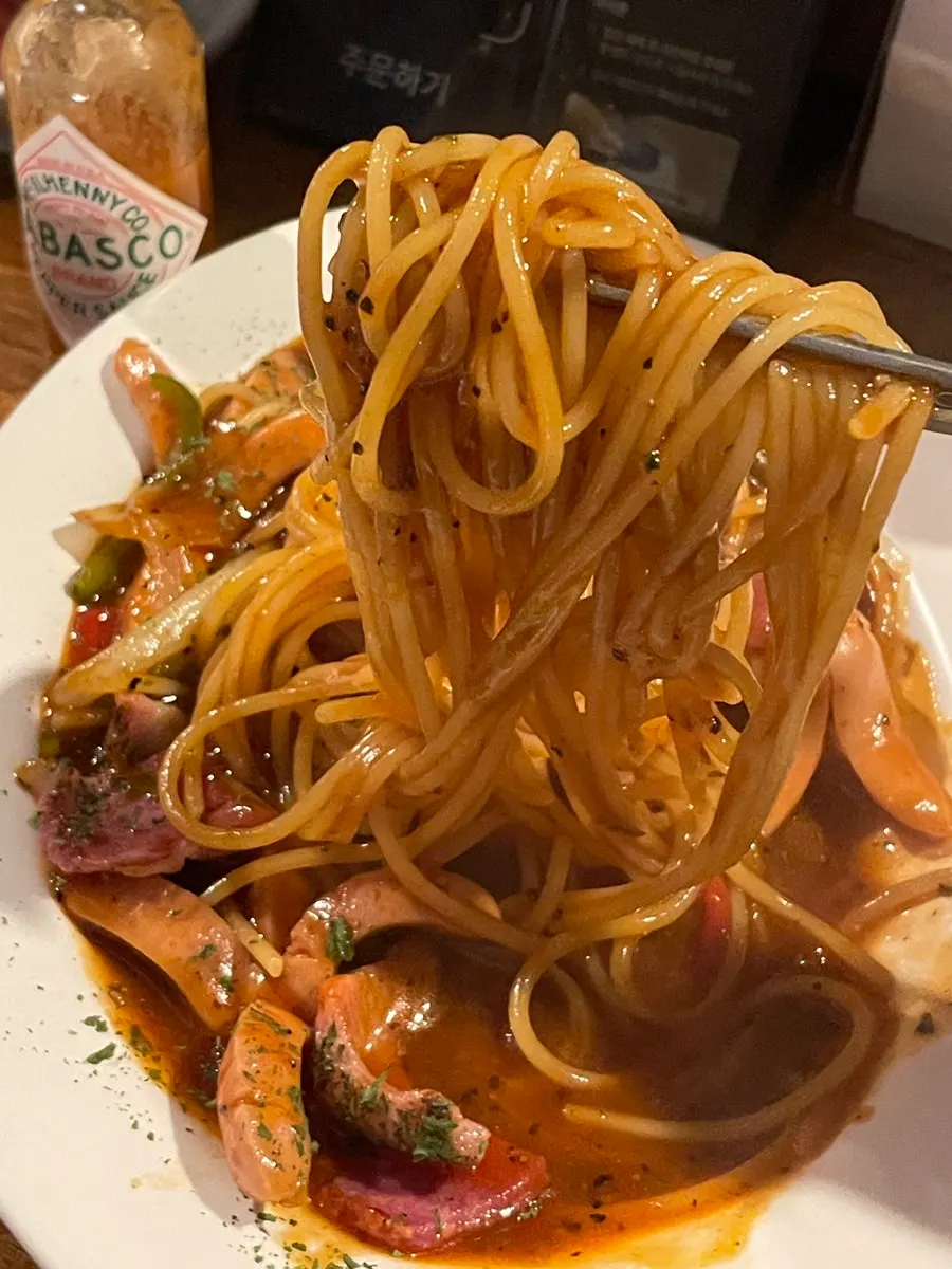 Forkful of Neapolitan pasta noodles lifted up