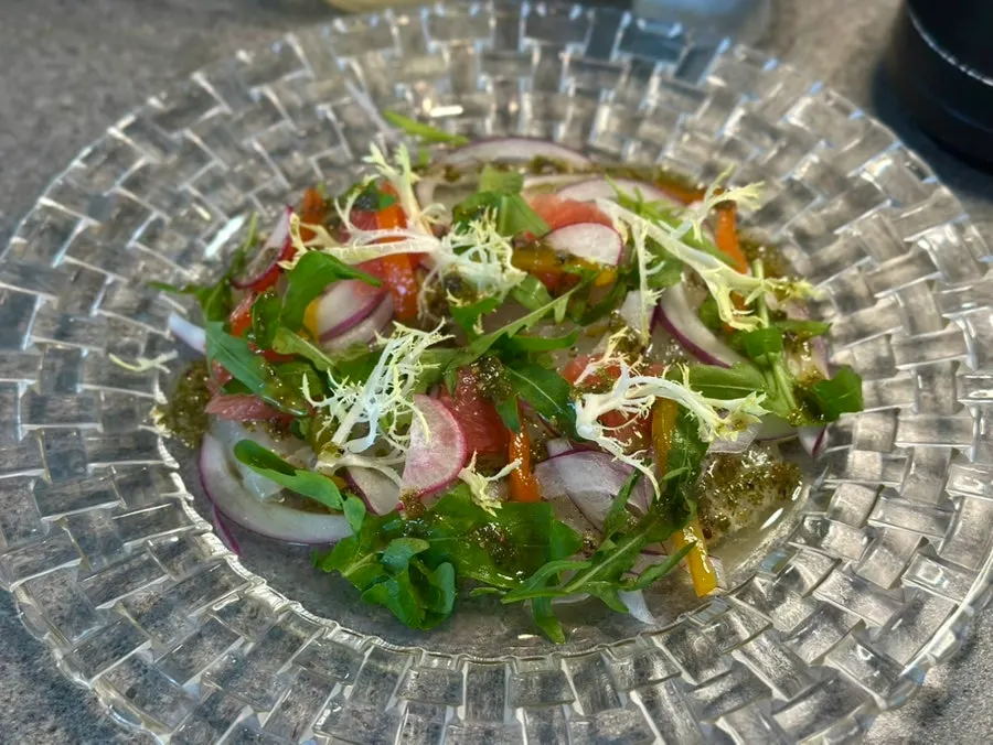 Flounder ceviche topped with herbs and grapefruit