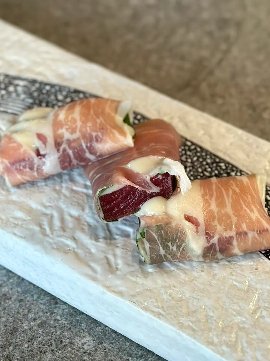 Close-up of raw tuna prosciutto finished with truffle oil