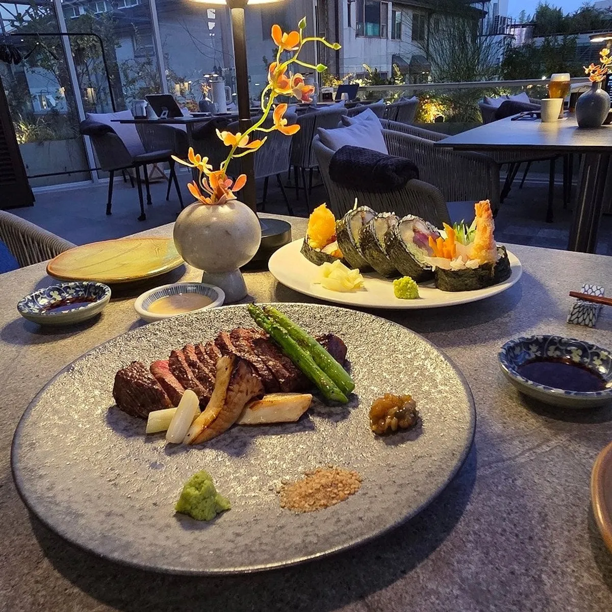 Starters and beer set on the table at Osa Cheongdam