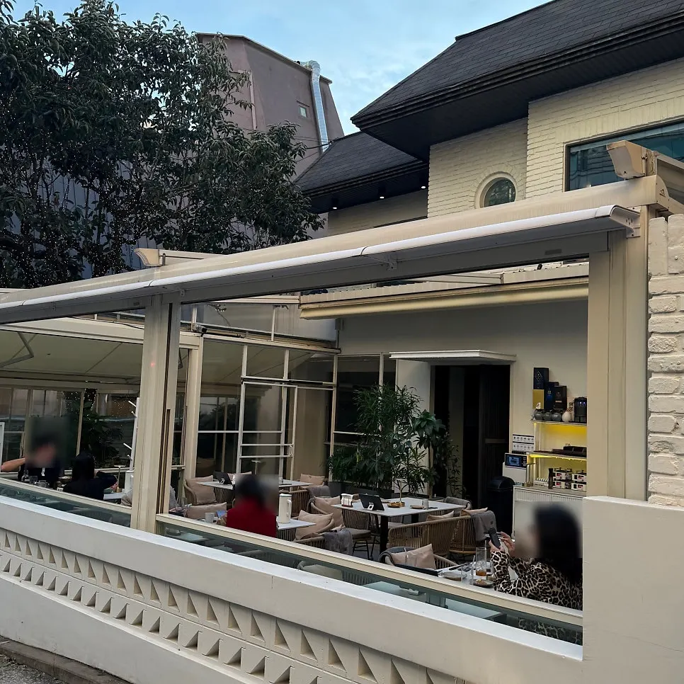 Guests dining on the white-toned terrace