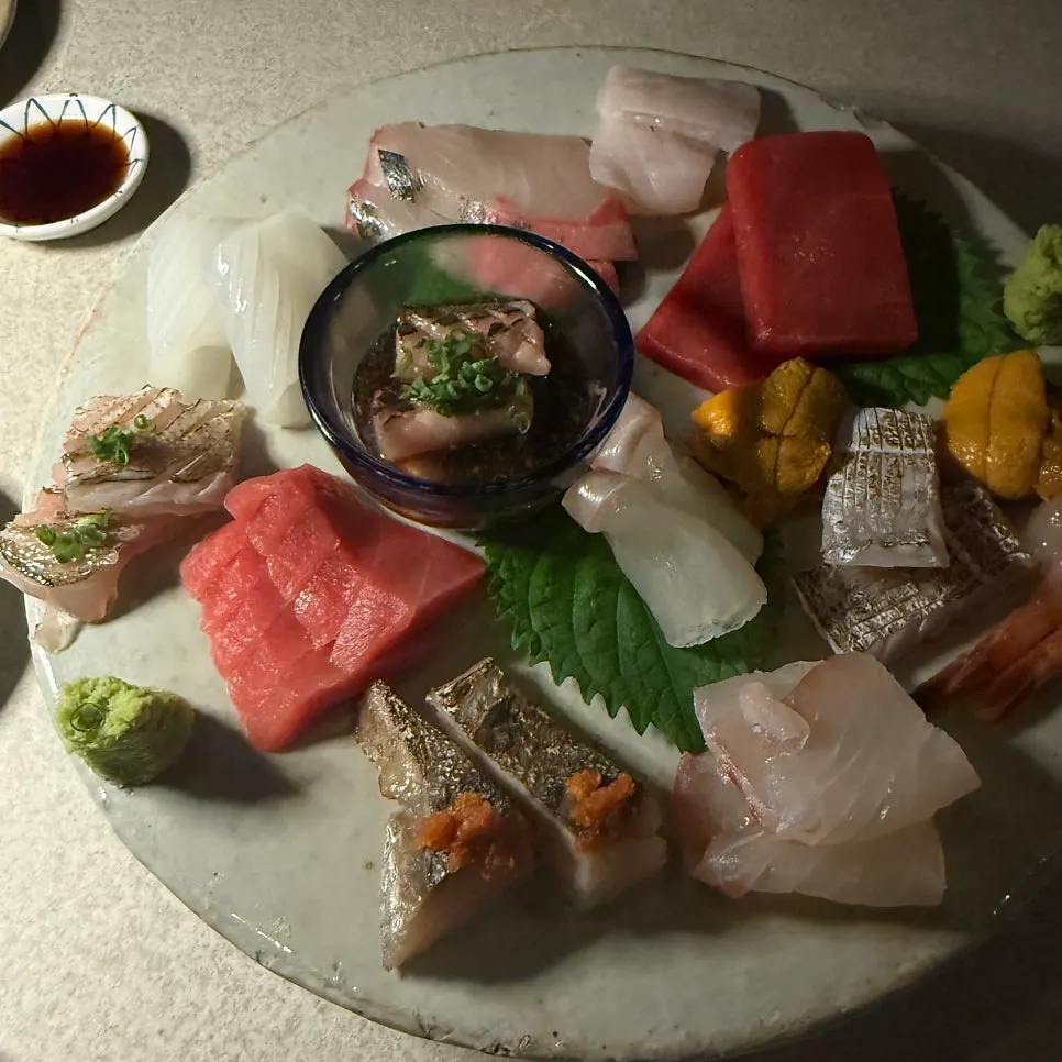 Seasonal sashimi platter served on a white porcelain plate
