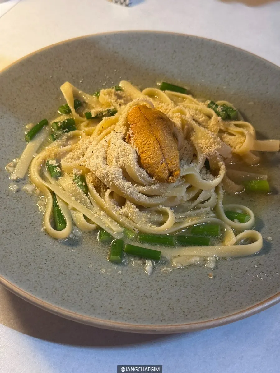 Visual of butter garlic pasta topped with uni