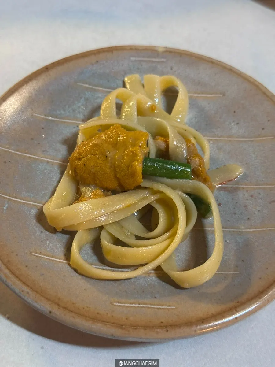 Uni pasta mixed and served with garlic scapes