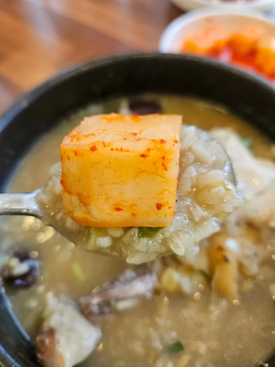 A bite of chicken topped with kkakdugi