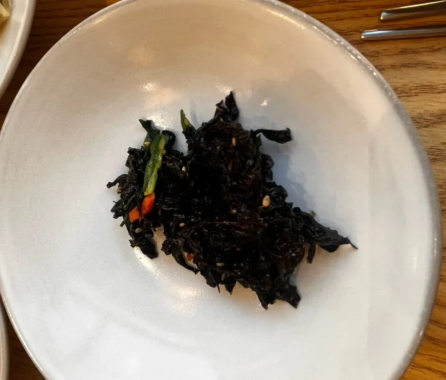 Side dishes served in ceramic bowls at Ossamgak