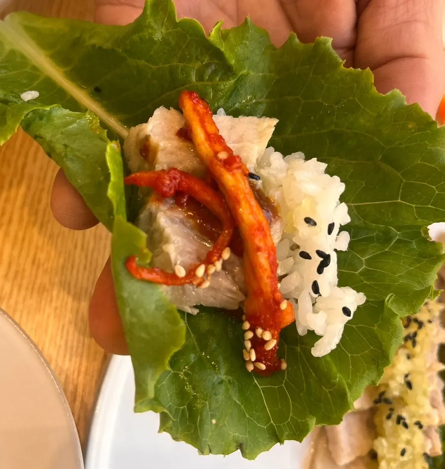 Garlic, kimchi, and julienned radish served with bossam