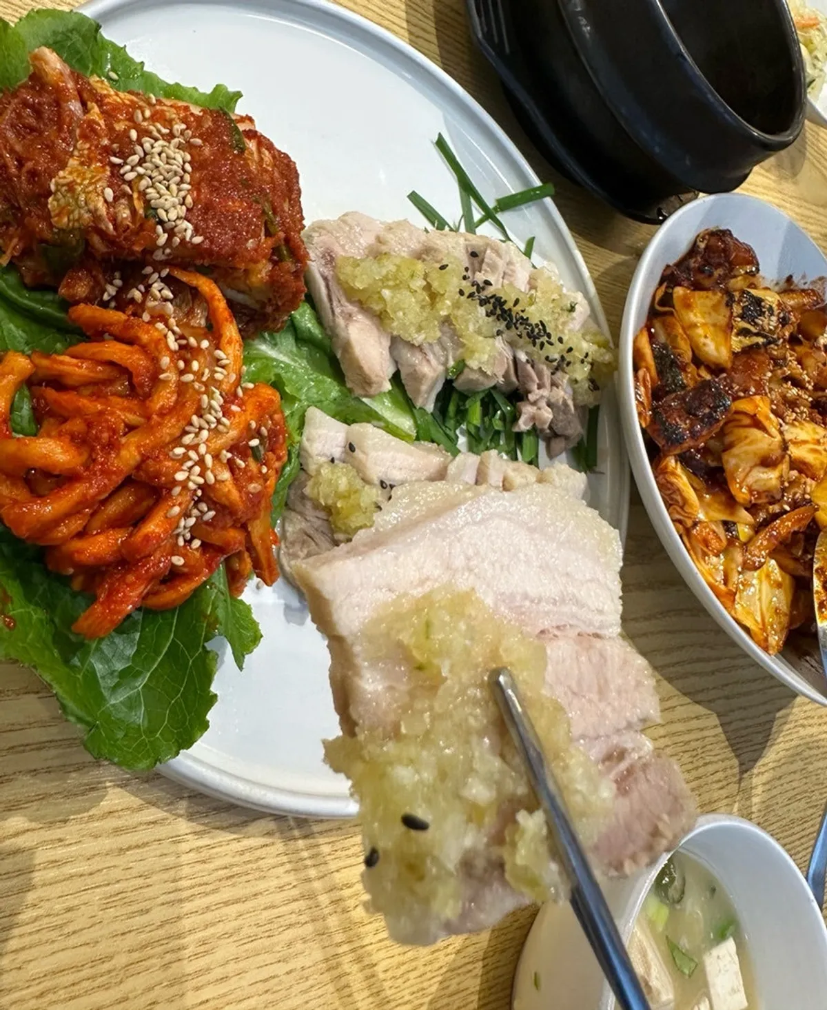 Bossam and house-made kimchi wrapped in lettuce