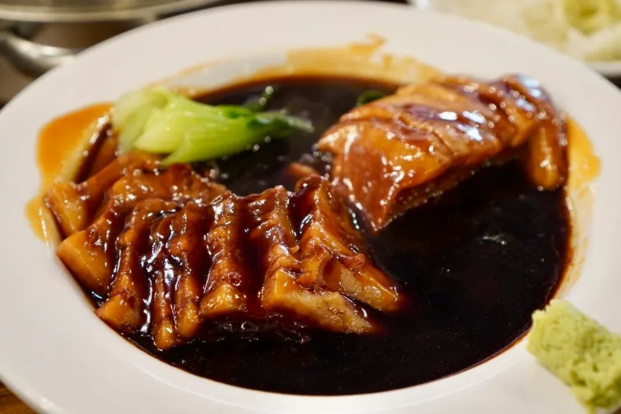 Stone-pot jjajang eaten with a bowl of rice