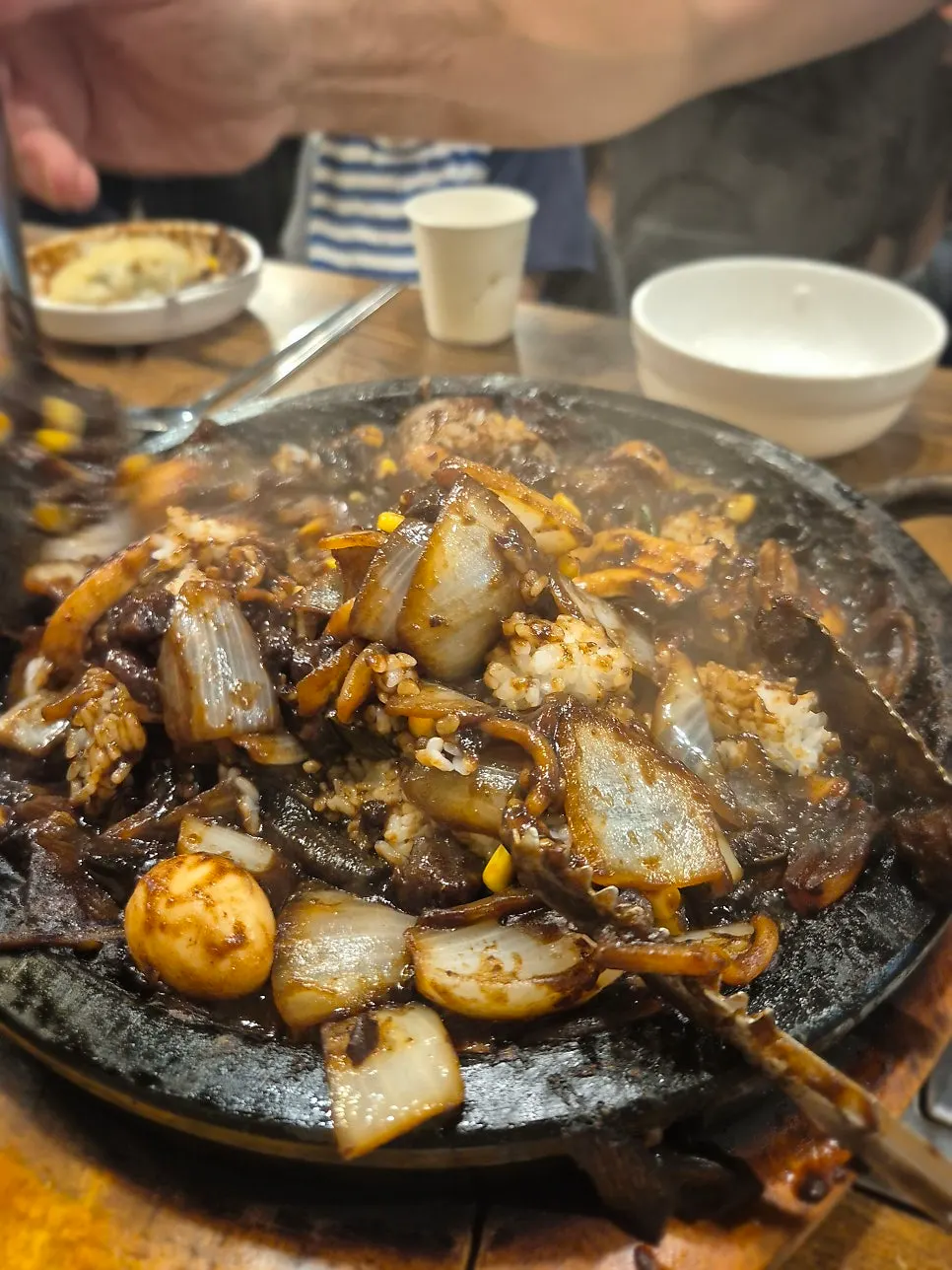 Rice added into the leftover jjajang sauce on the stone plate