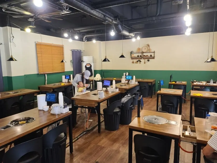 Spacious dining hall tables inside Dami Sik