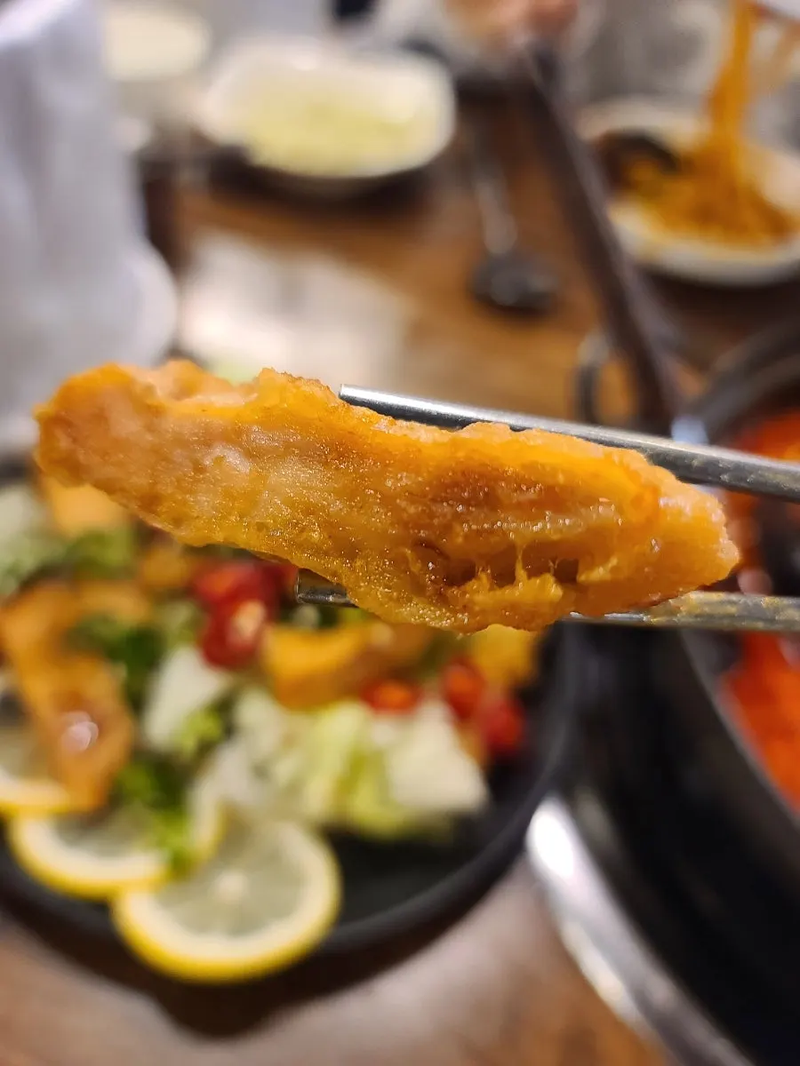 Close-up of yuringi topped with sweet-sour sauce