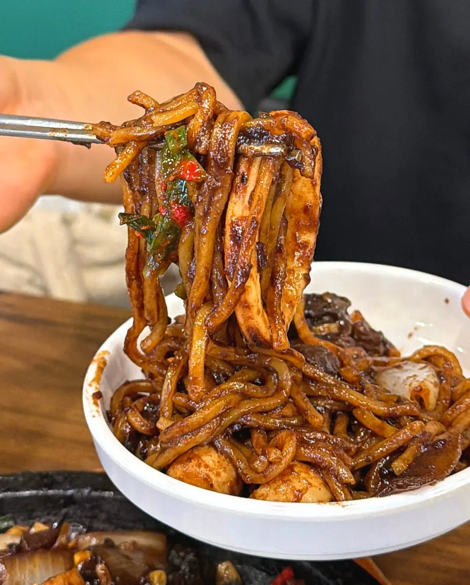 Stone jjajang kept warm on a stone plate