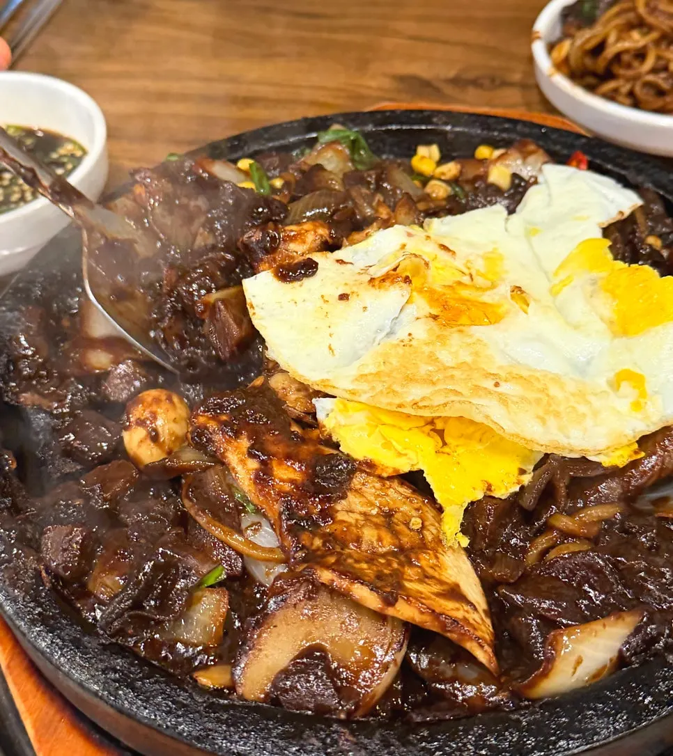 Stone jjajang noodles lightly crisped against the plate