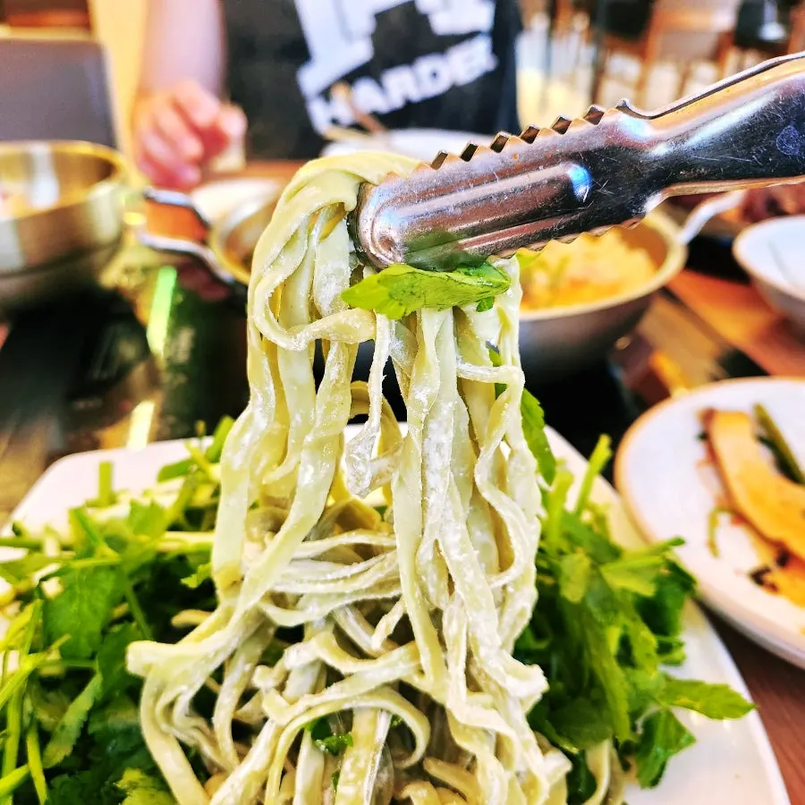 A bite of shabu shabu dipped in soy sauce