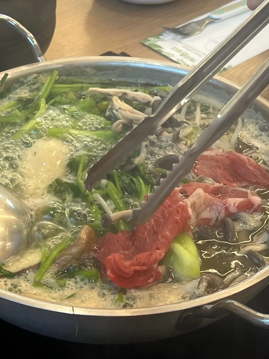 Clear-broth shabu shabu boiling on the table