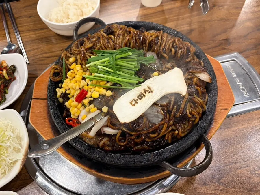 Spicy stone jjajang served on a hot stone plate at Dami Sik