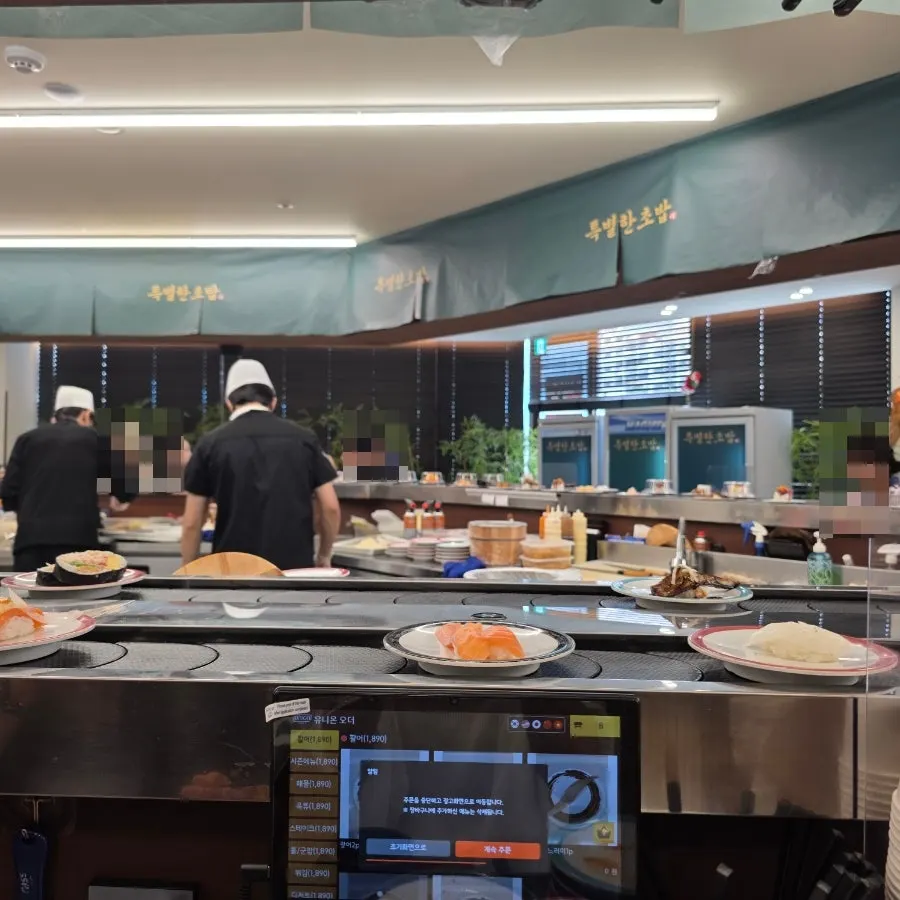 Interior with conveyor-belt sushi rail and bar seating