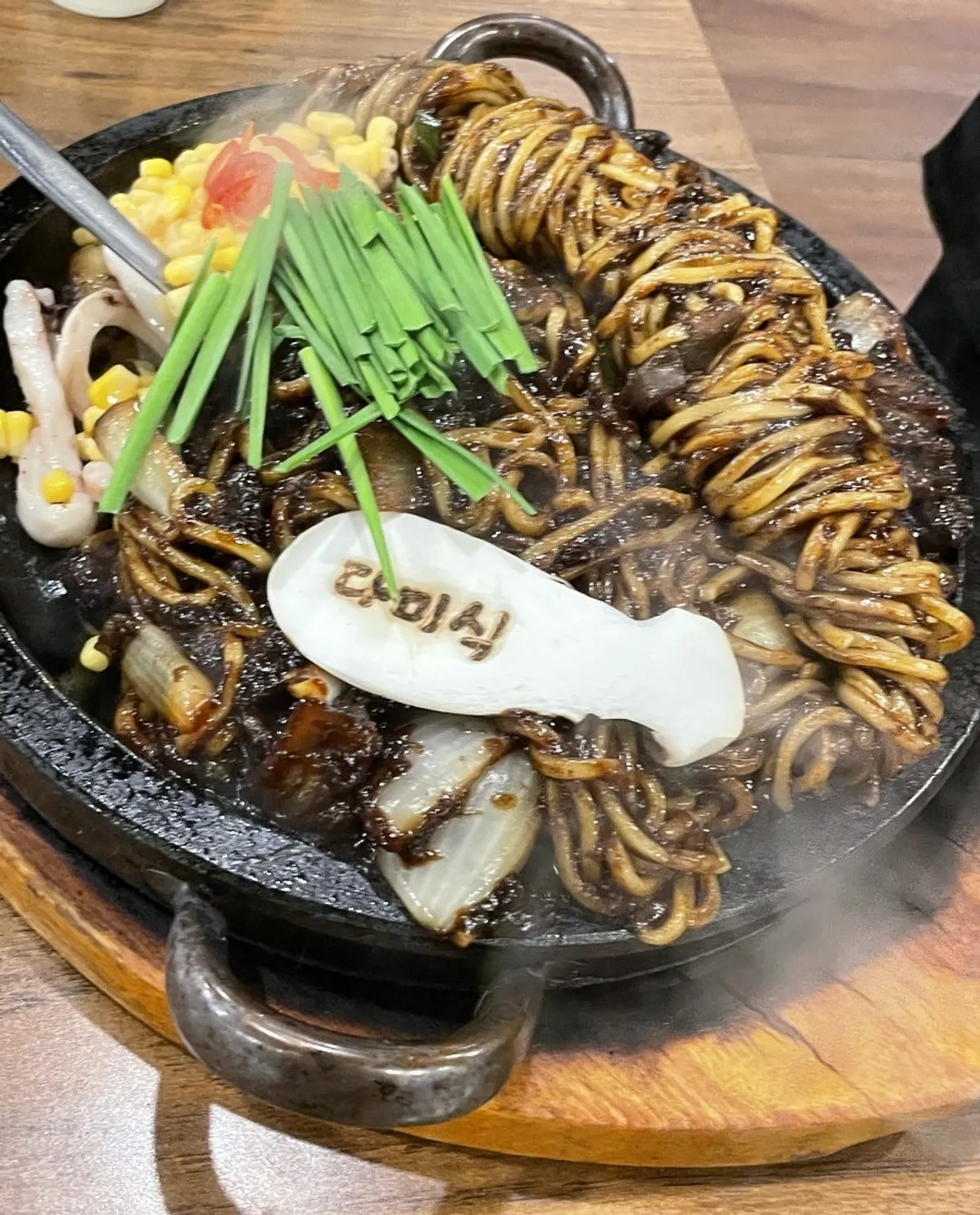 Stone jjajang sizzling on the hot stone plate