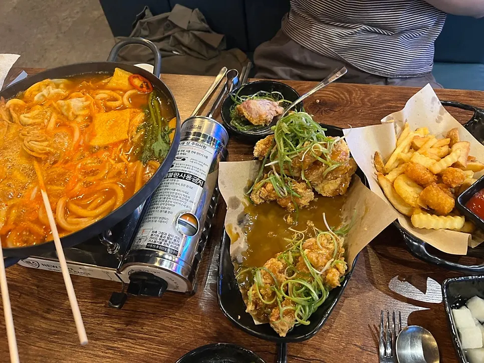 Skewered fish cake and dumplings inside the kimchi eomuk udon