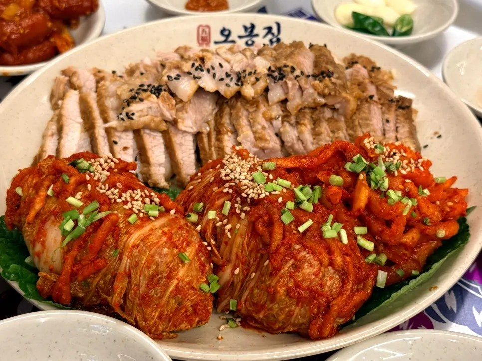 Table spread with bossam and side dishes