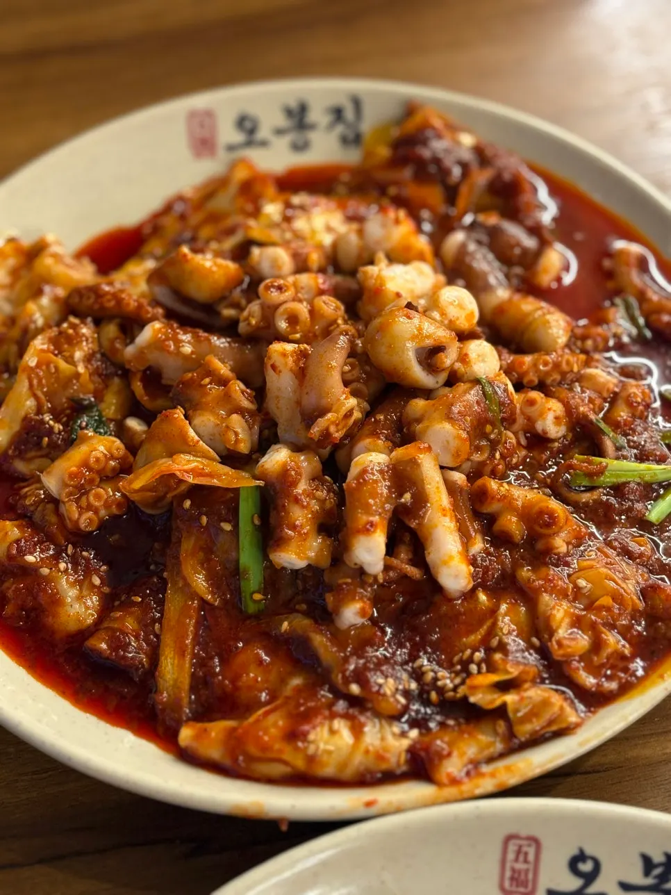 Octopus cut with scissors alongside mixed noodles