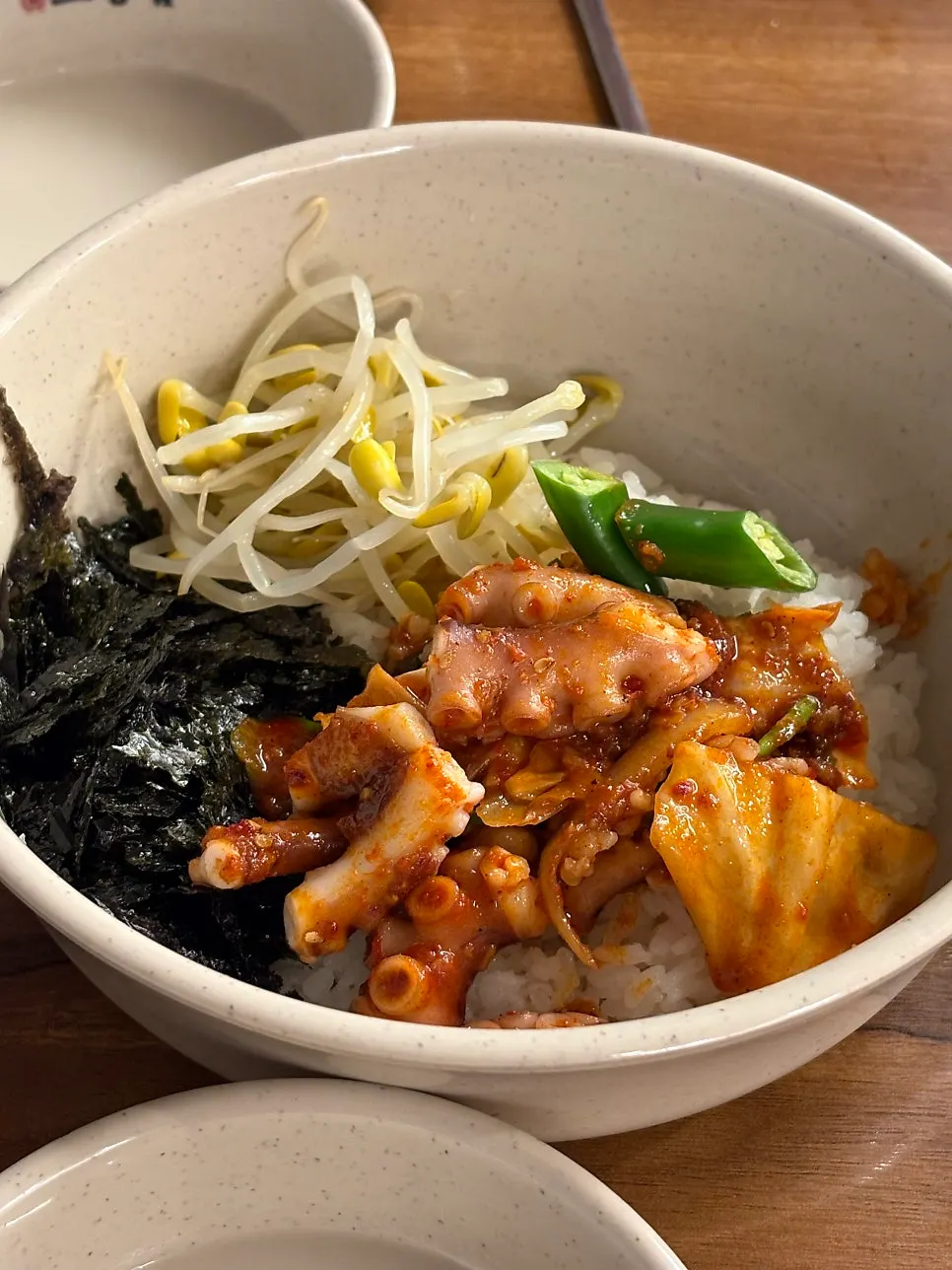 Octopus and sauce piled onto a bowl of rice