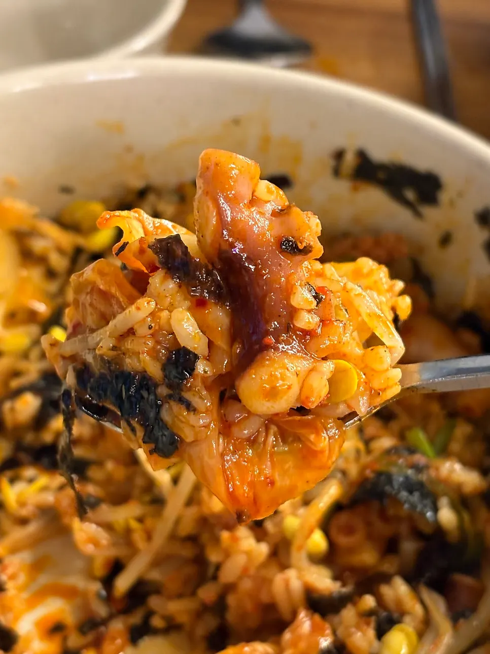 Octopus bibimbap mixed with a drizzle of sesame oil