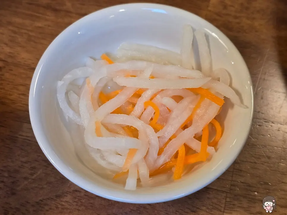 Carrot and radish pickles served as a side dish with table setting