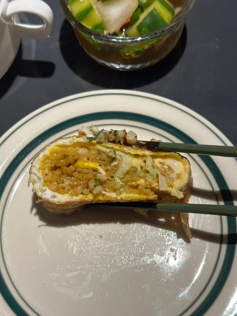 Cross-section of the pork belly roll split with chopsticks