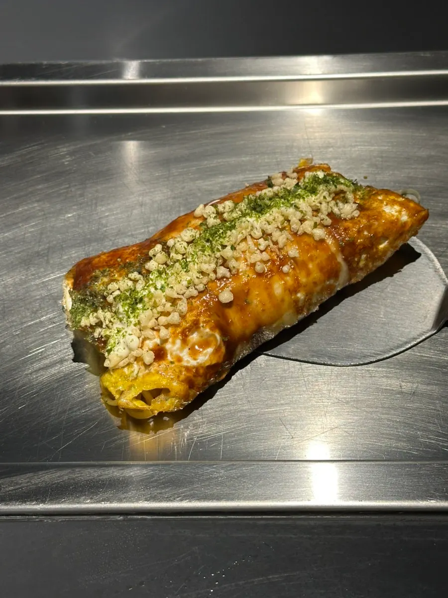 Yakisoba pork belly rolls topped with fried flakes and seaweed powder