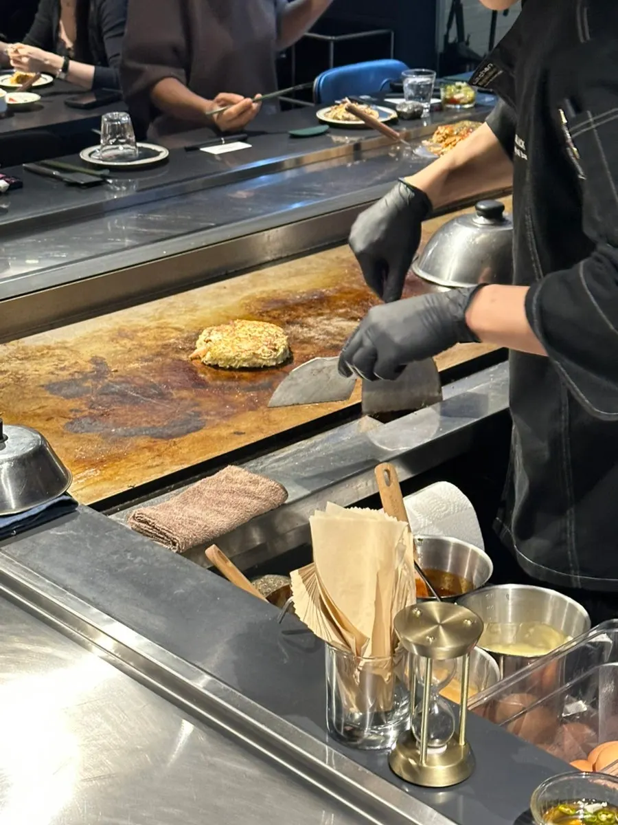 A piece of oshinomiyaki cooked crispy outside, moist inside