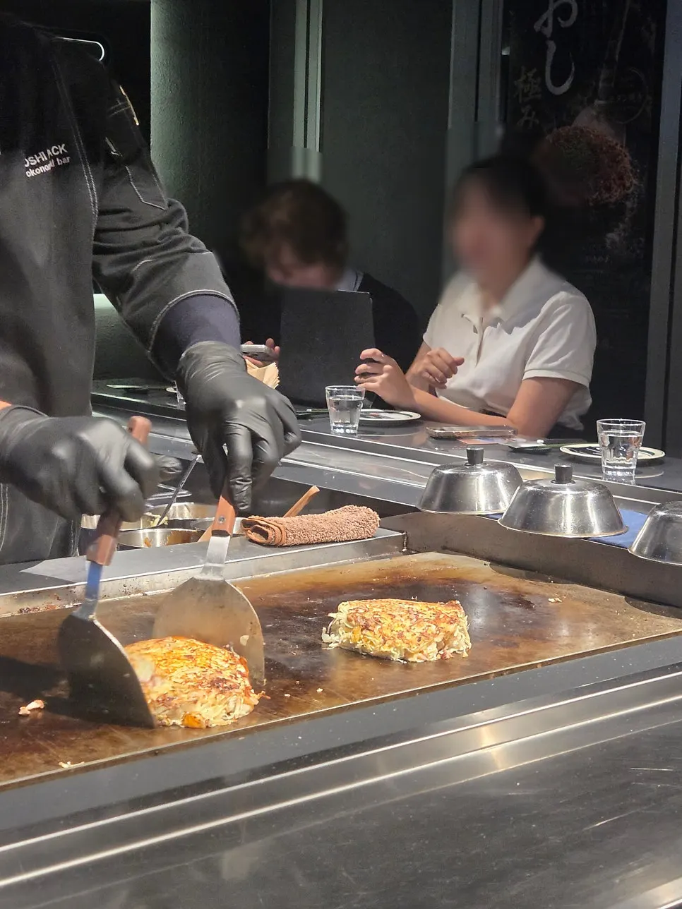Cooking in progress on the teppan in front of the bar table