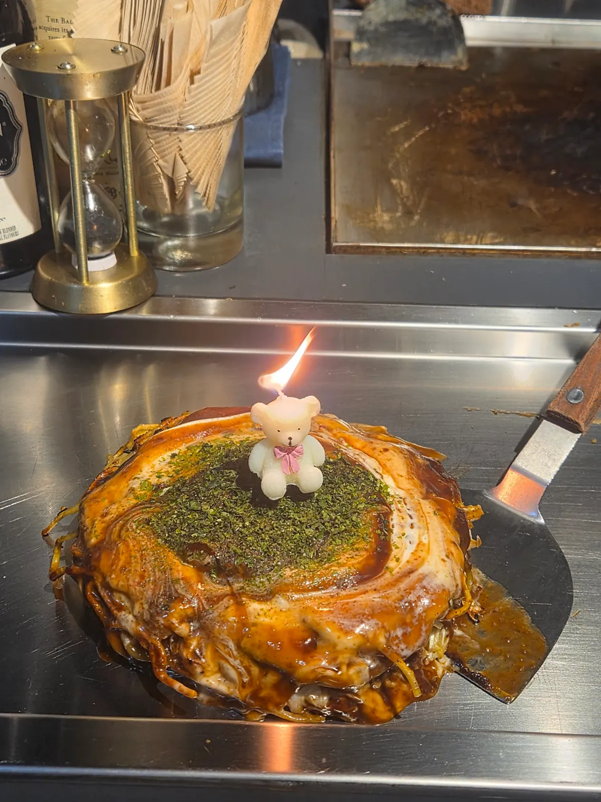 Oshi Modan-yaki with a bear-shaped candle stuck in it