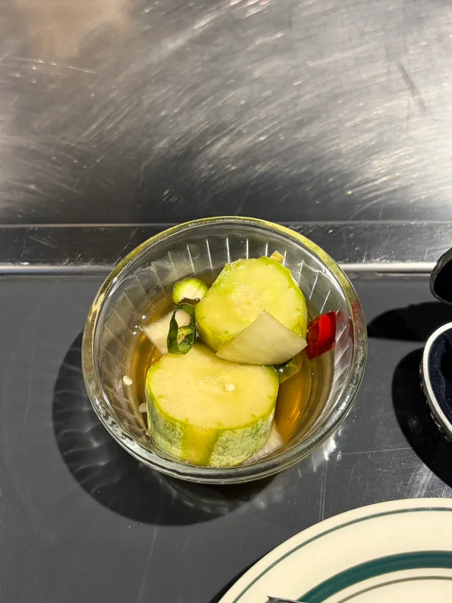 Complimentary cucumber salad at the bar table