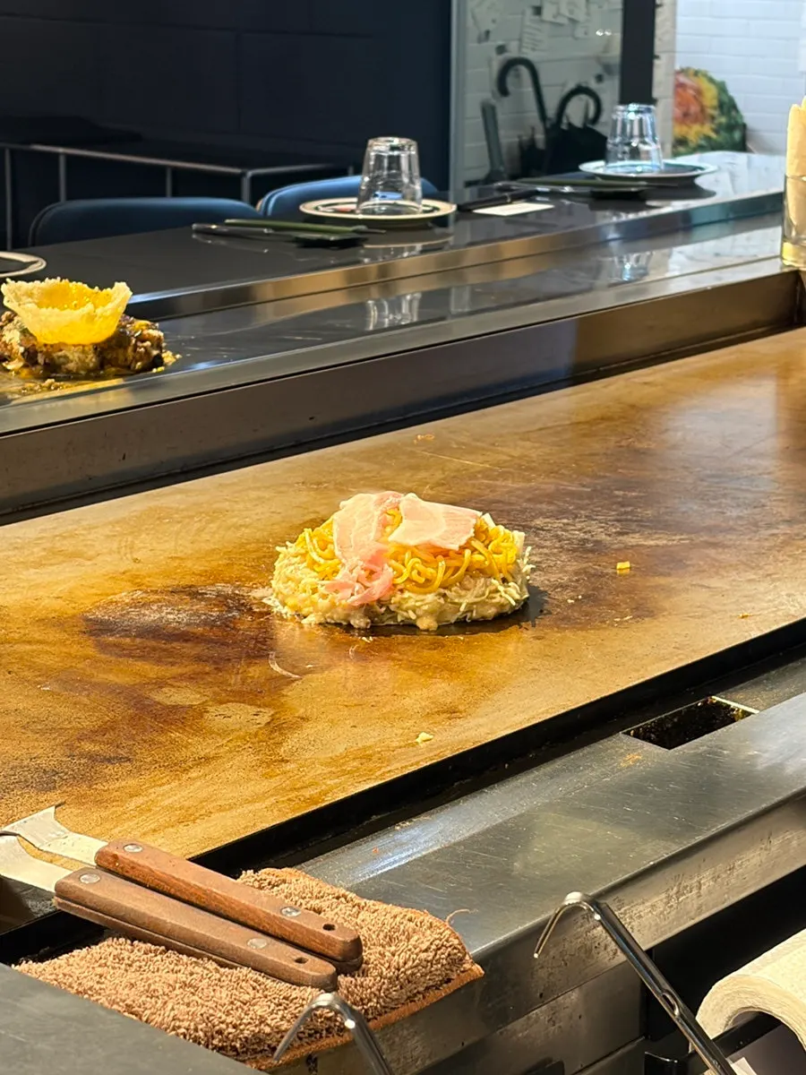 Oshi Modanyaki batter cooking on the teppan