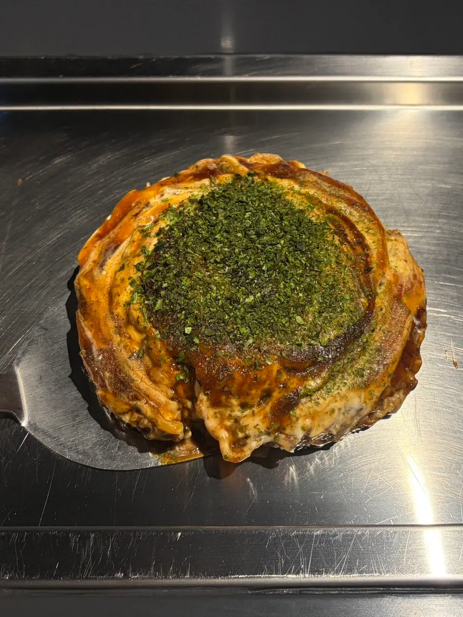Okonomiyaki generously drizzled with sauce