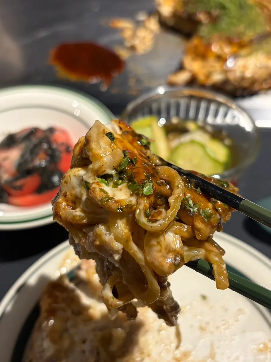 Cross-section of Modanyaki packed with noodles, cabbage and meat