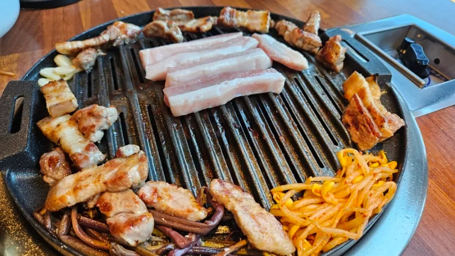 Thick pork belly grilling on the barbecue
