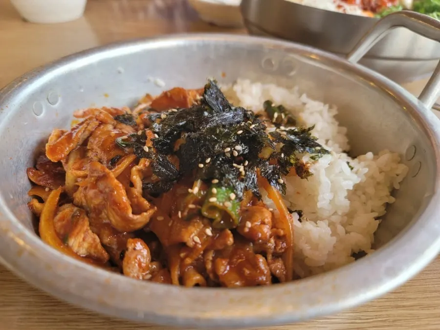 Spicy pork rice bowl served in an aluminum pot