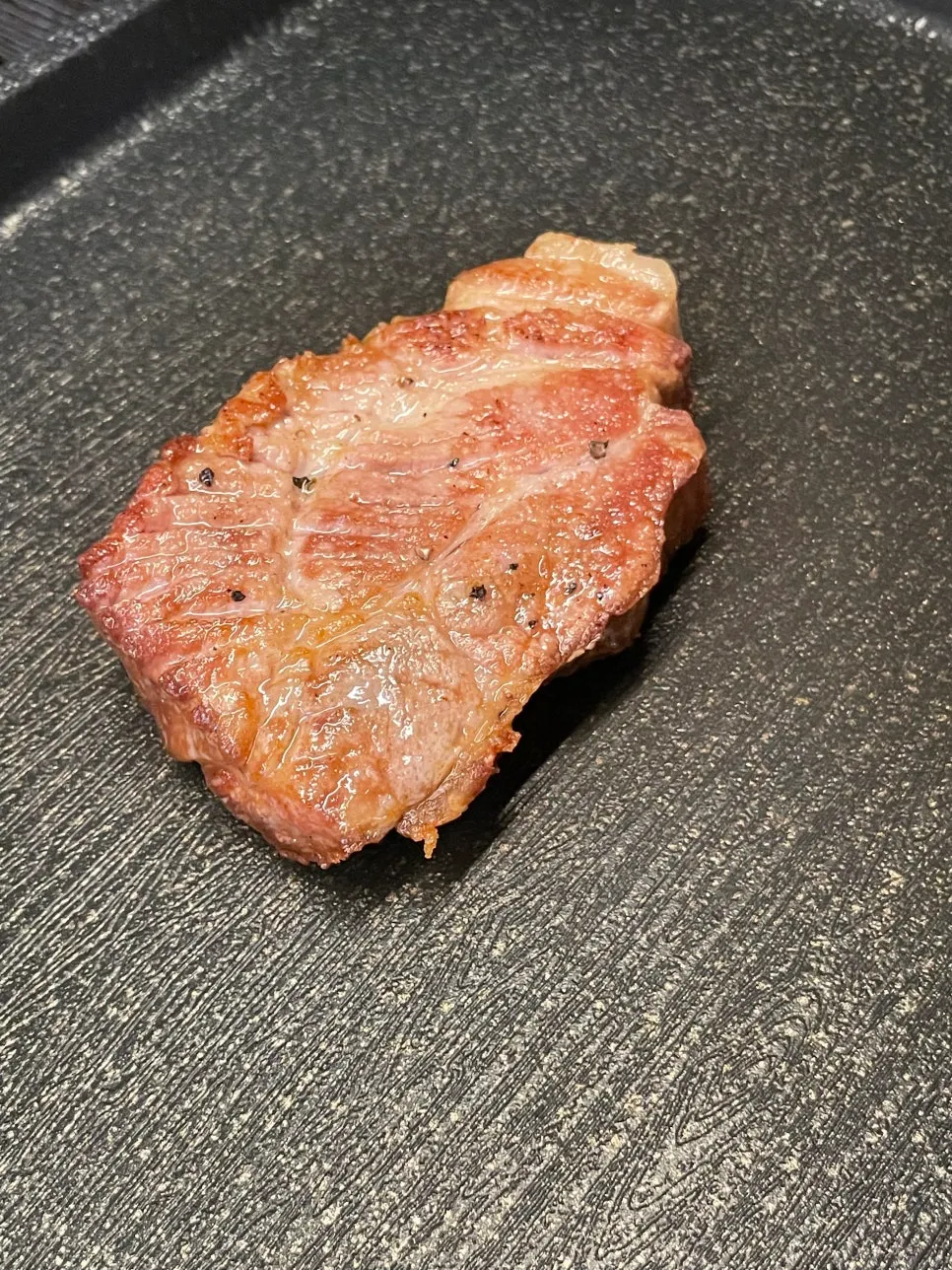Pre-grilled meat placed on the grill
