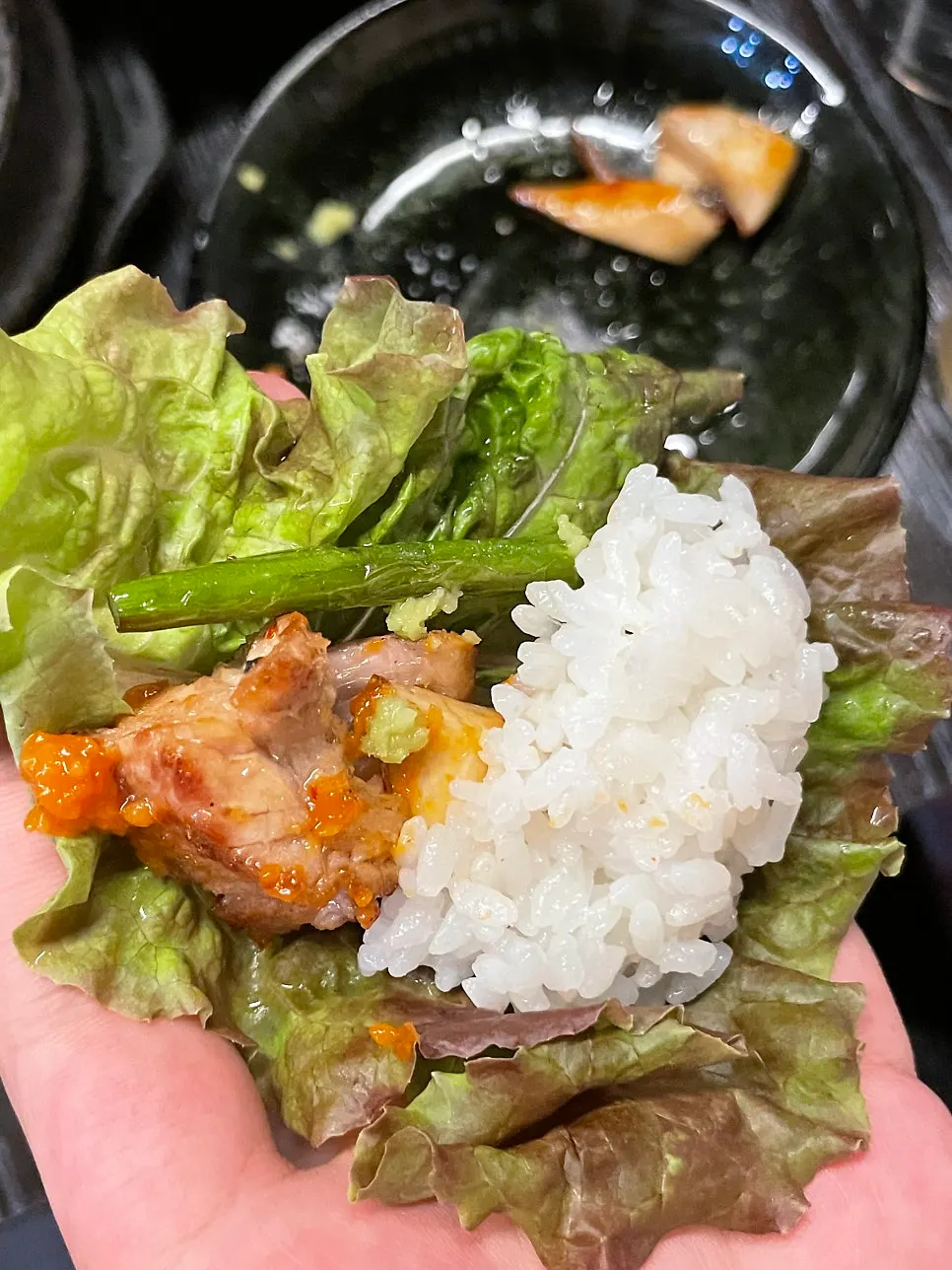 A piece of meat placed in a lettuce wrap