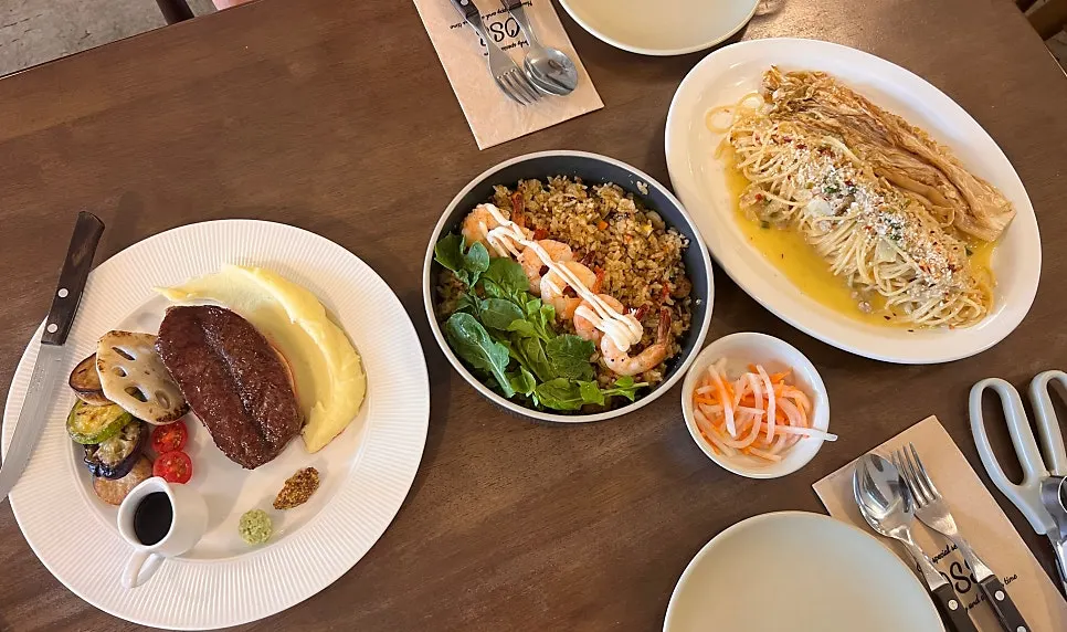 House steak, shrimp pilaf, and aged kimchi pasta together on the table