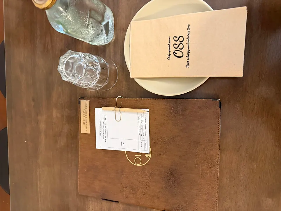 Interior of Oseuseu with wooden tables and soft lighting