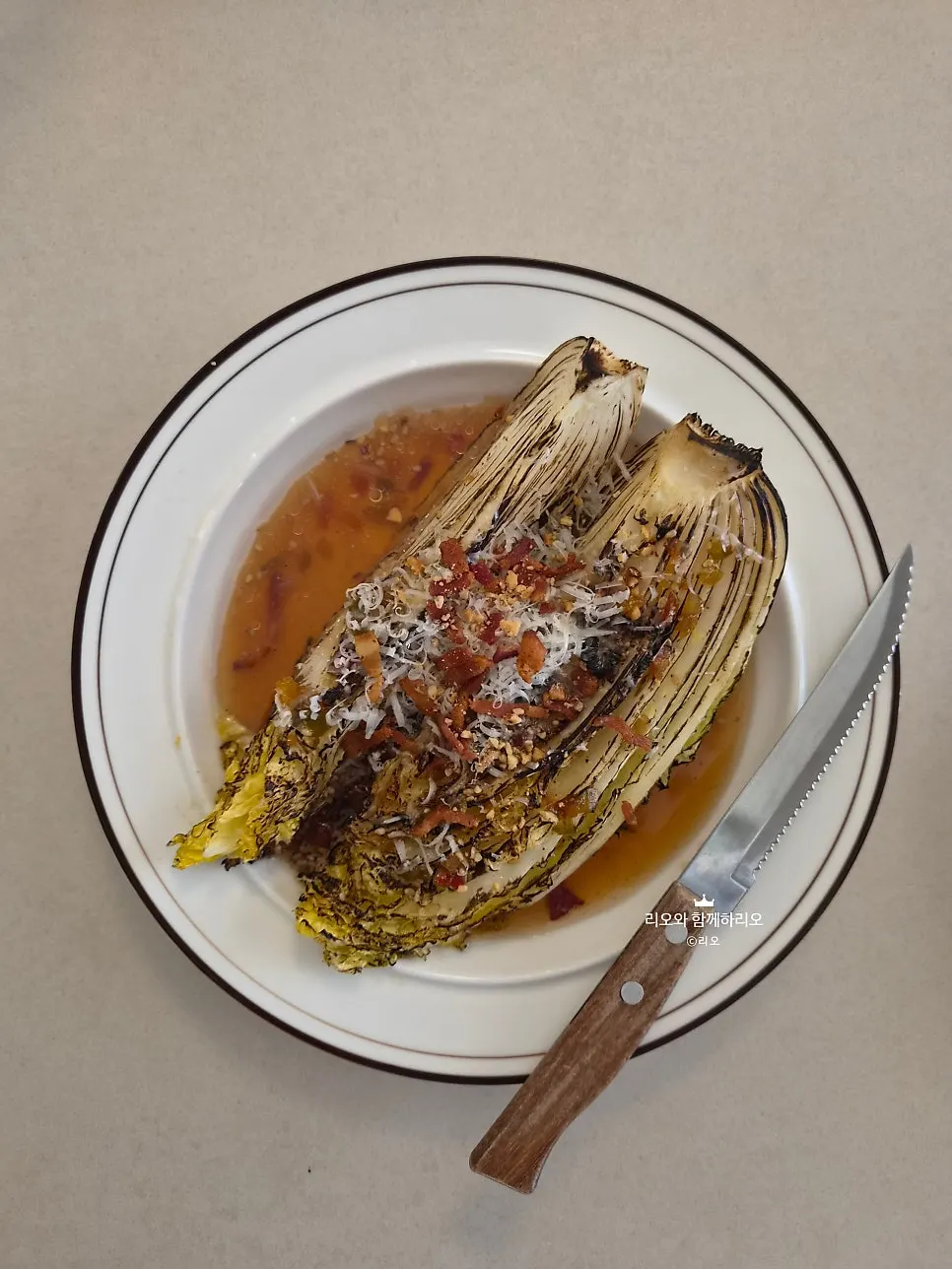 Plating of Oseuseu's grilled napa cabbage salad