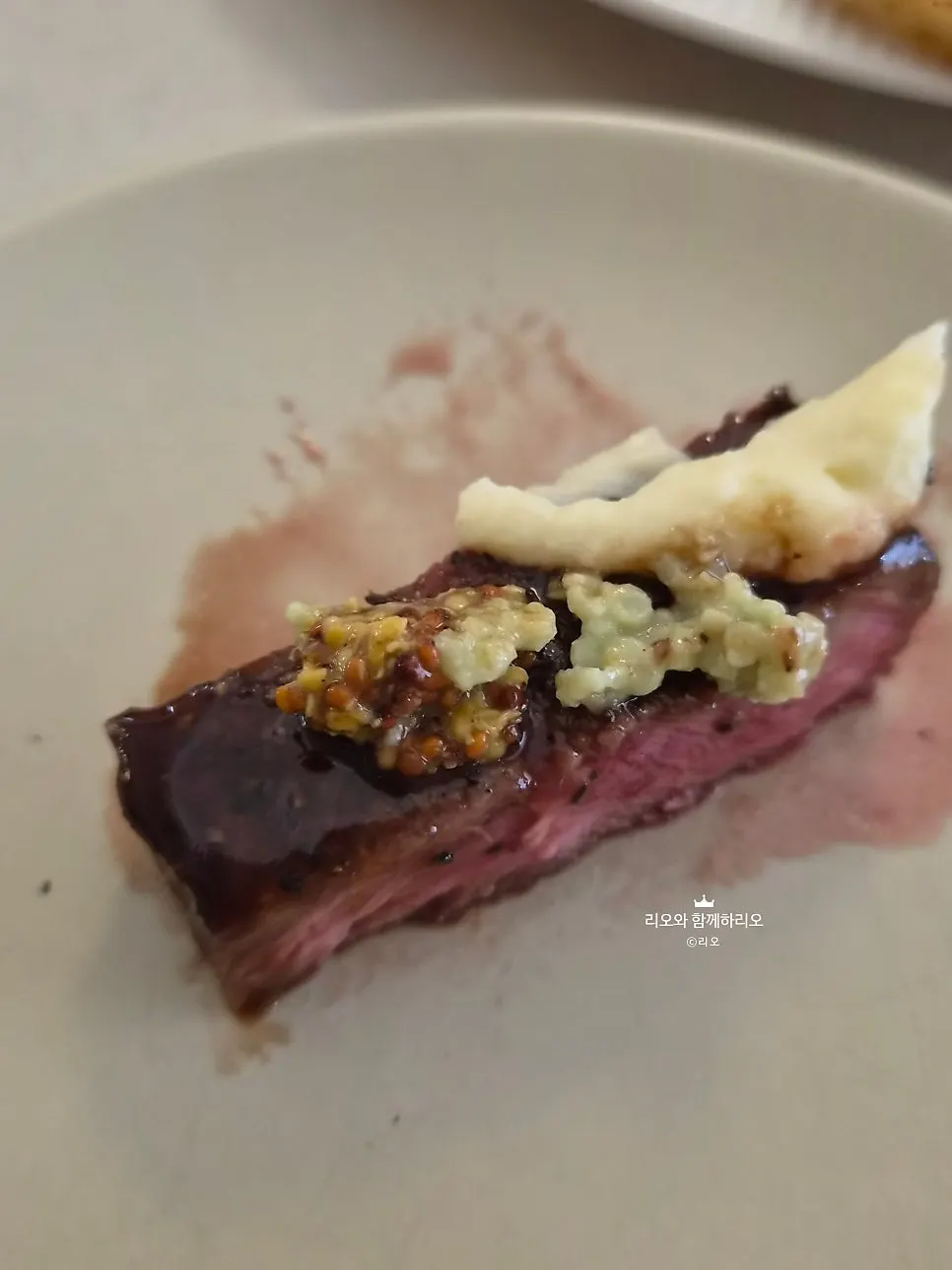 Mashed potato layered beneath the steak