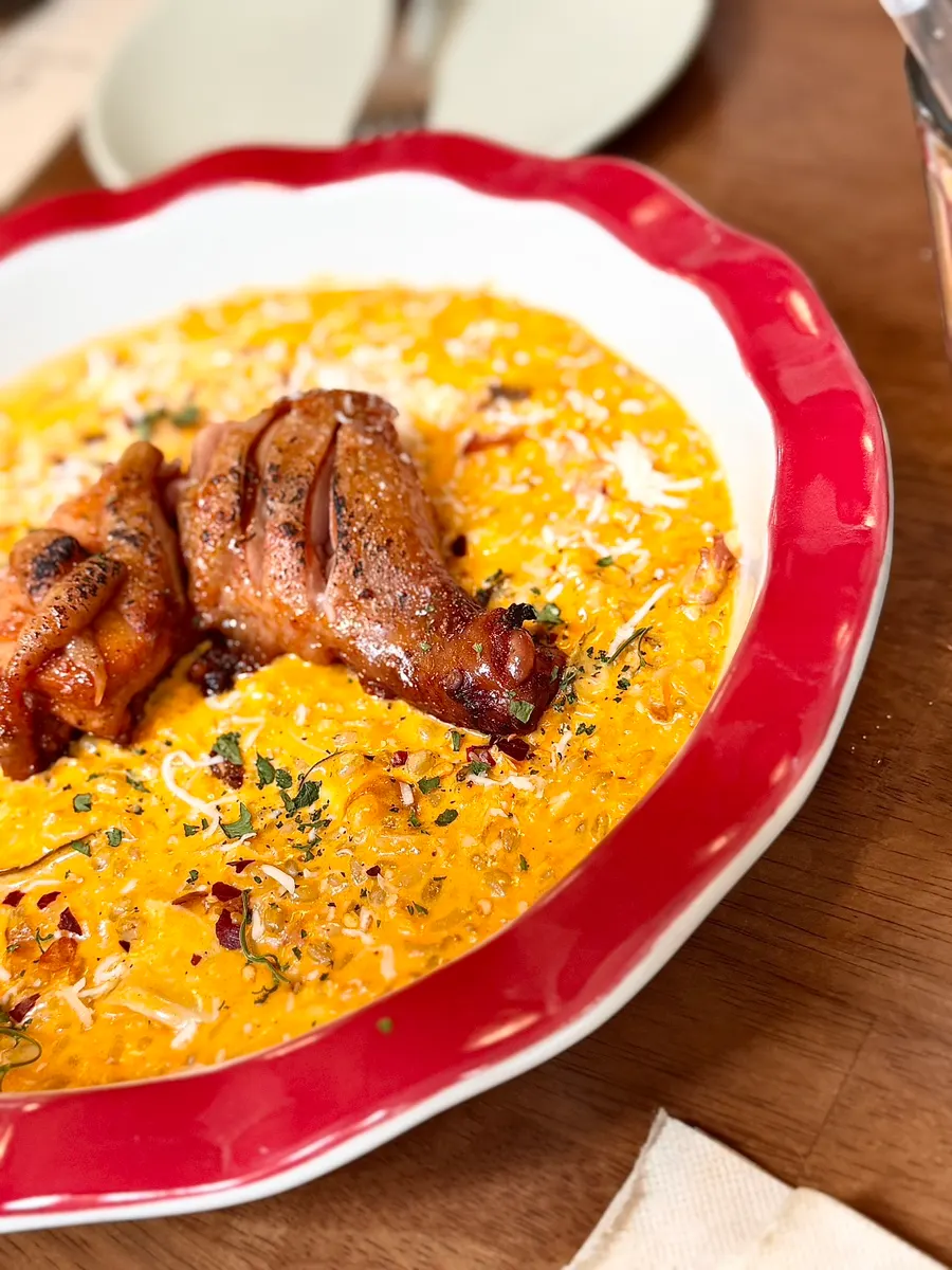 Spicy chicken risotto served in a red-rimmed bowl