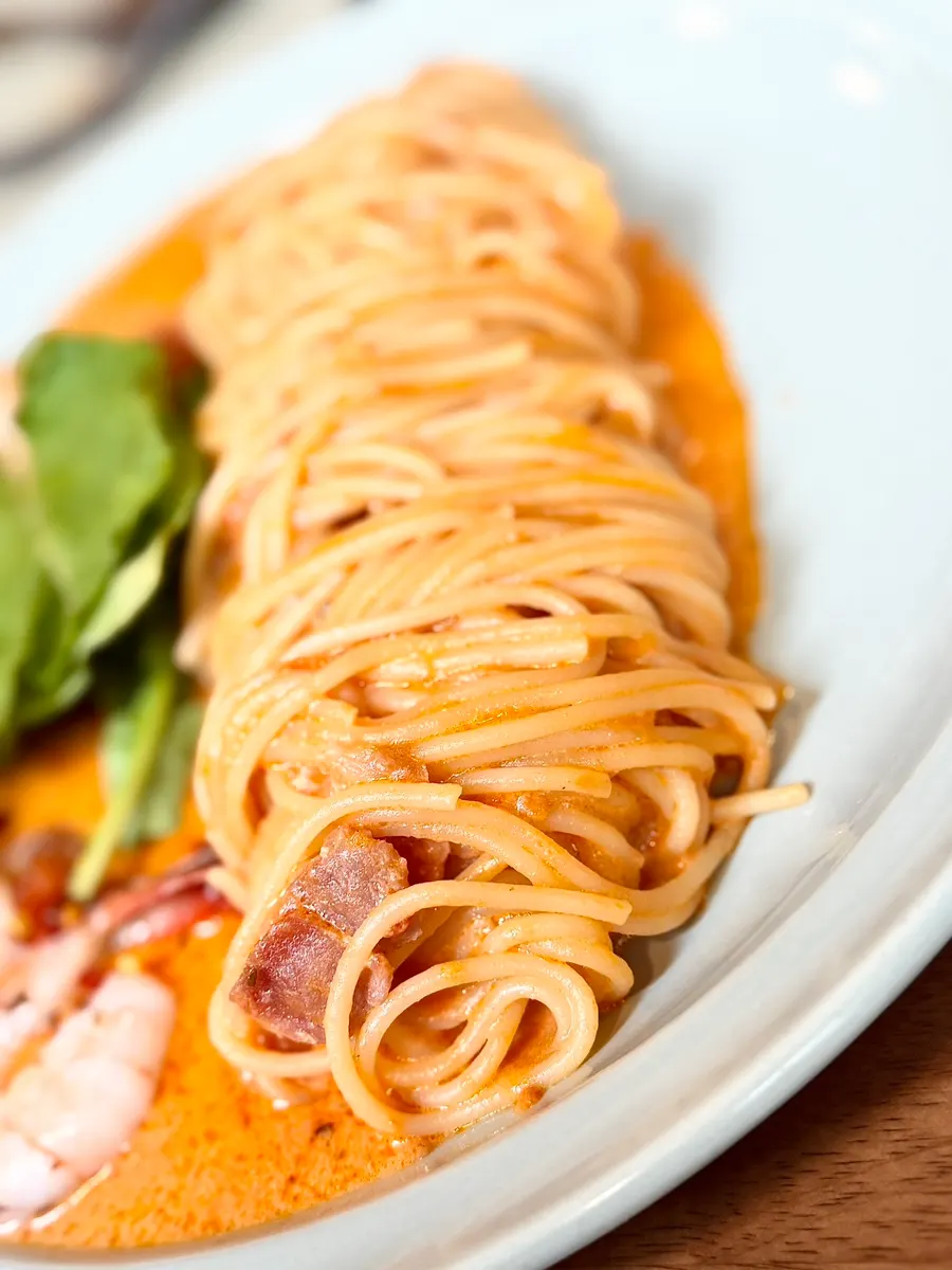 A bite of rosé pasta with a thick shrimp