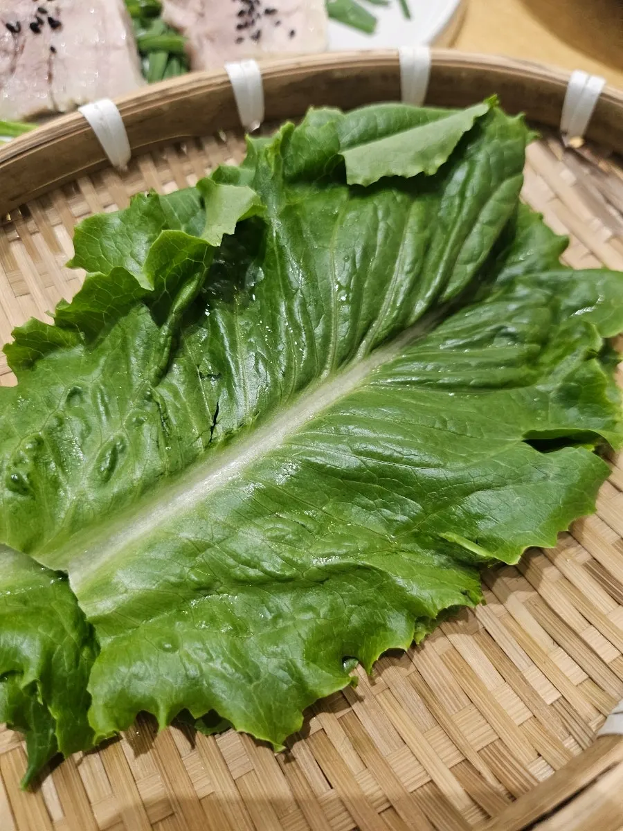 Ossamgak garlic bossam served with bossam kimchi and seasoned sides