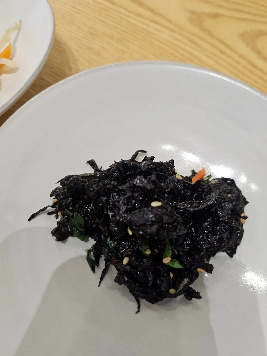 Basic side dishes at Ossamgak including seasoned chives and bean sprouts